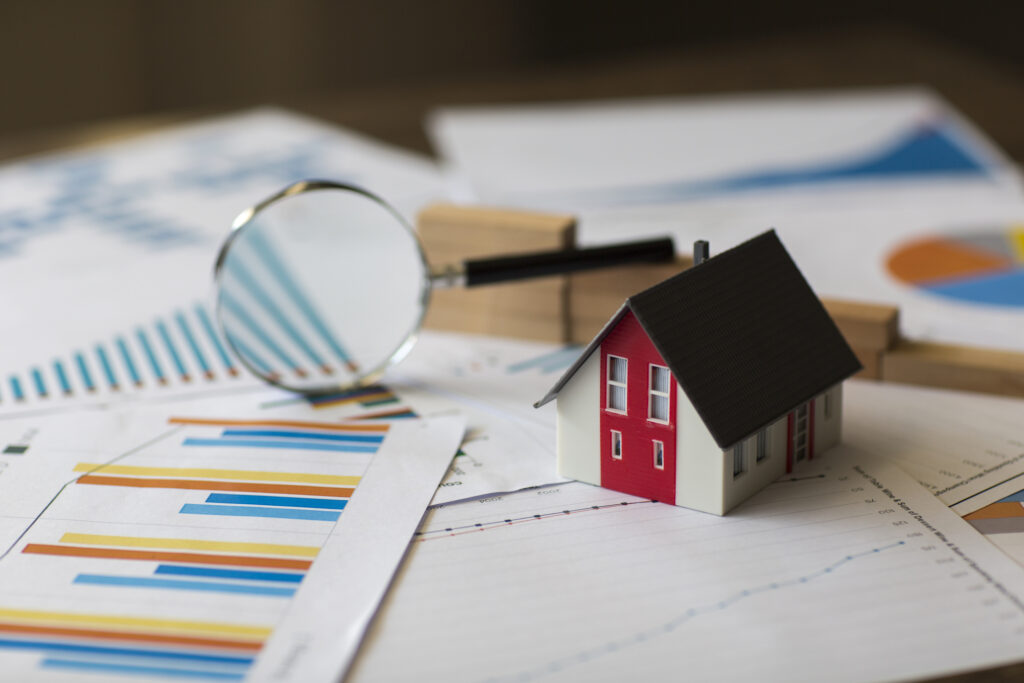 Miniature House on A Financial Graph