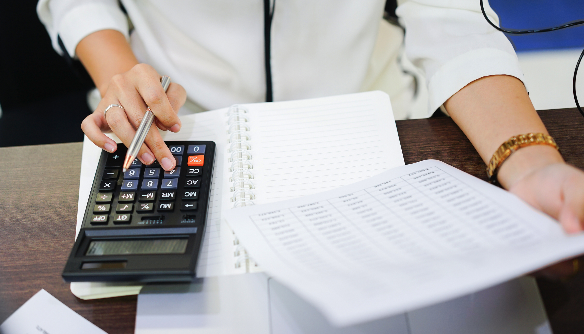 close up on woman hand pressing on calculator for calculating cost estimating , senior accountant job working concept